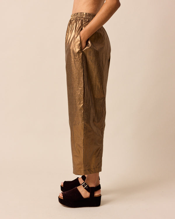 model wears mabel bronze linen trousers left
