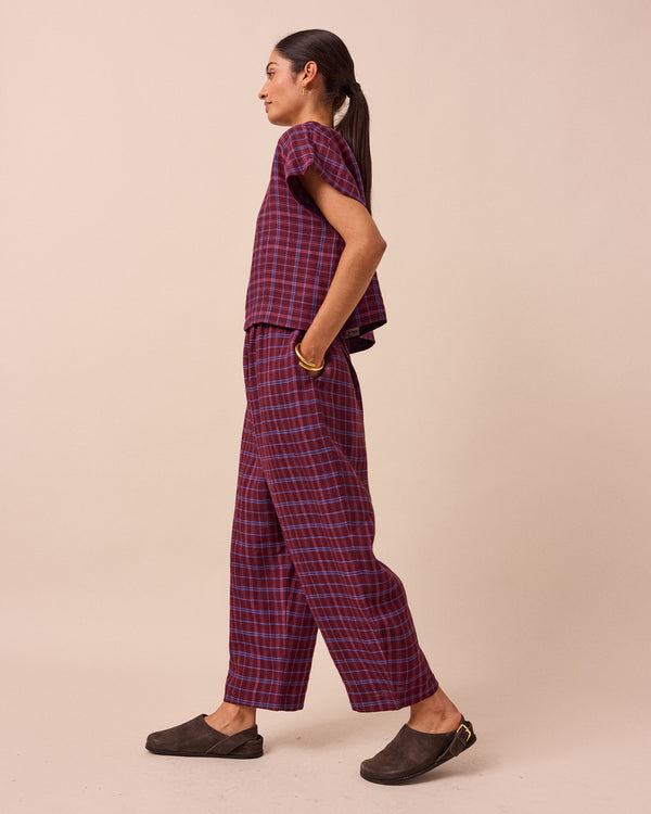 model wears mabel mulberry check linen trousers back
