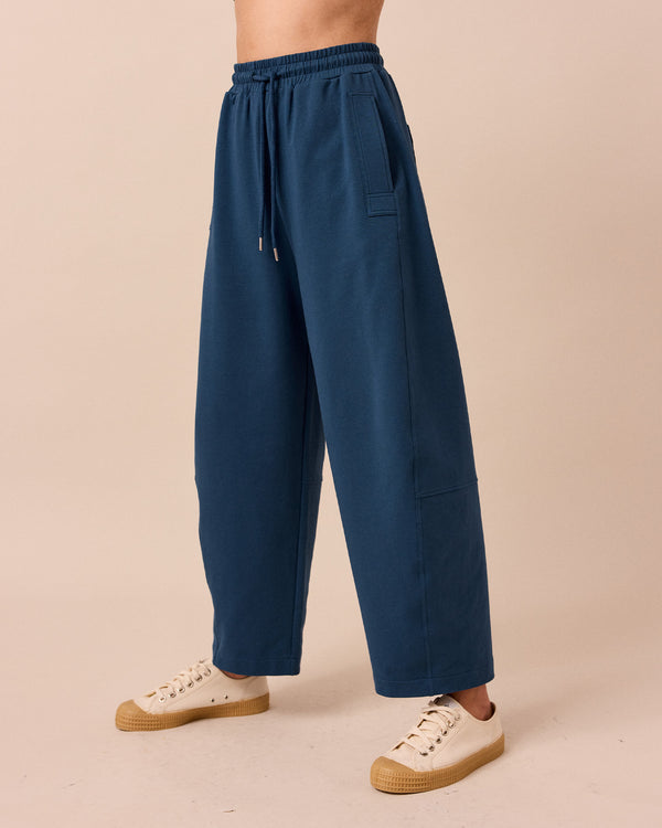 model wears madi french navy jersey trousers left