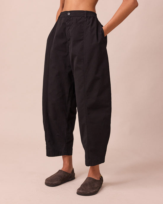 model wears millie black heavy cotton trousers left