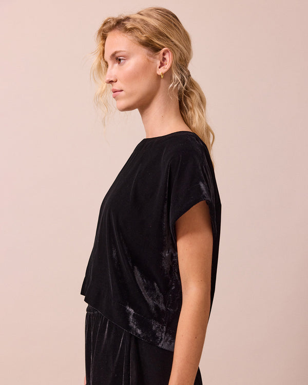 model wears polly black velvet top