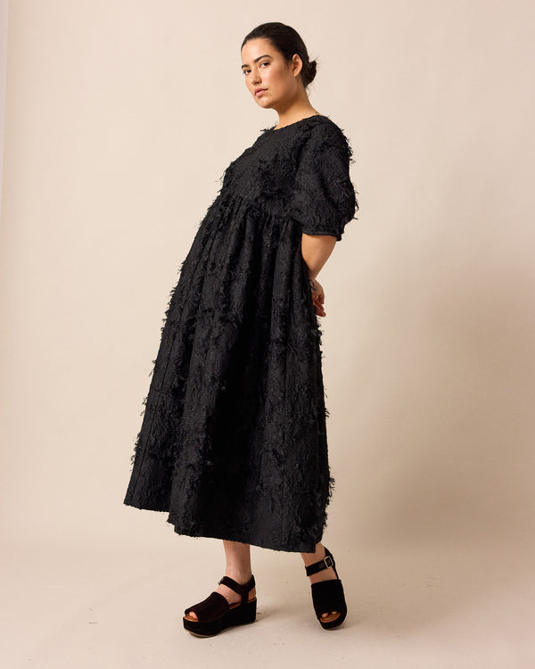model wears prue black tufted dress