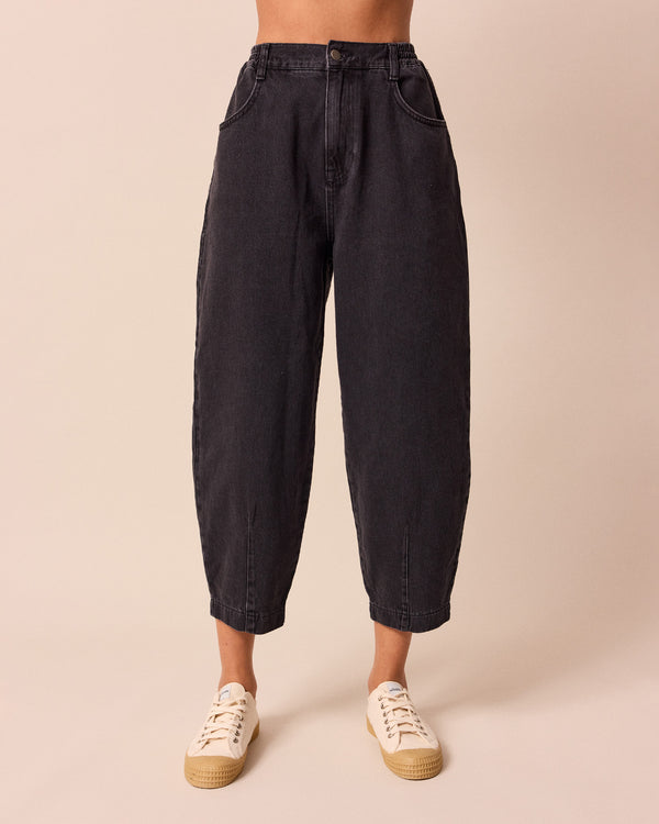 model wears remi washed black jeans front back