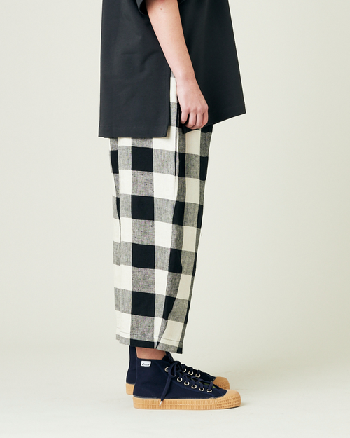 model wears stone and black mega check linen mabel trousers from the right