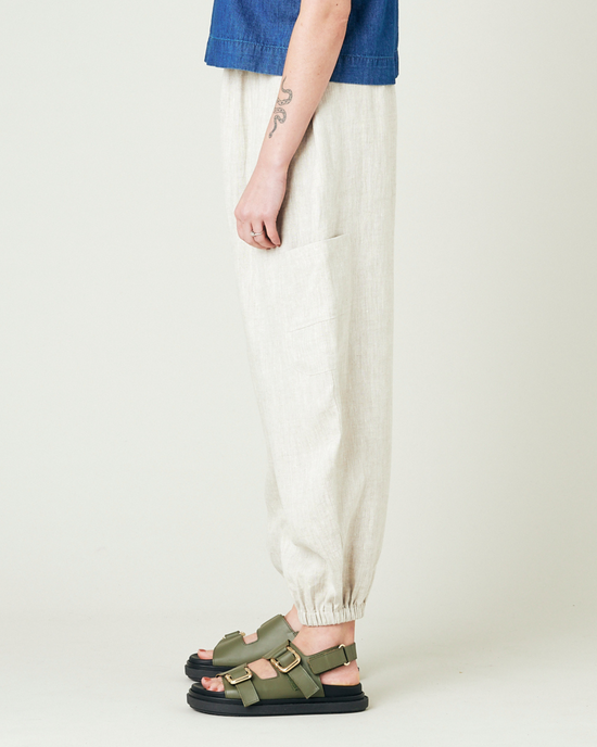 model wears natural linen yoli trousers left