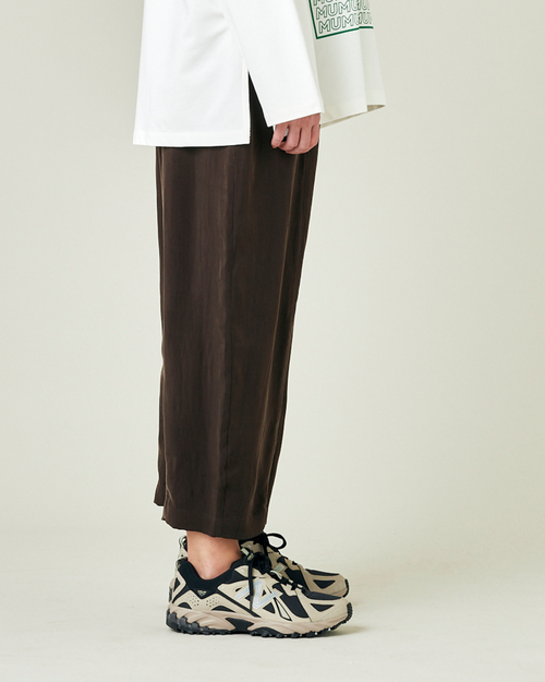 model wears espresso cupro mabel trousers right