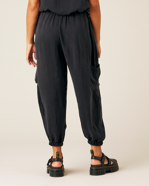 model wears black cupro yoli trousers back