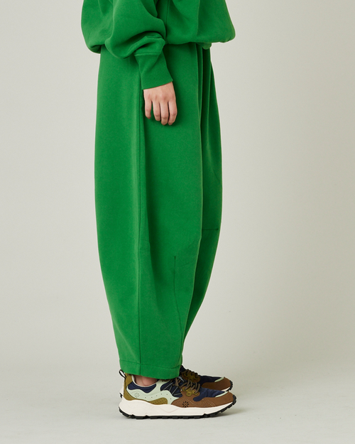 model wears juniper green daisy jersey trousers right