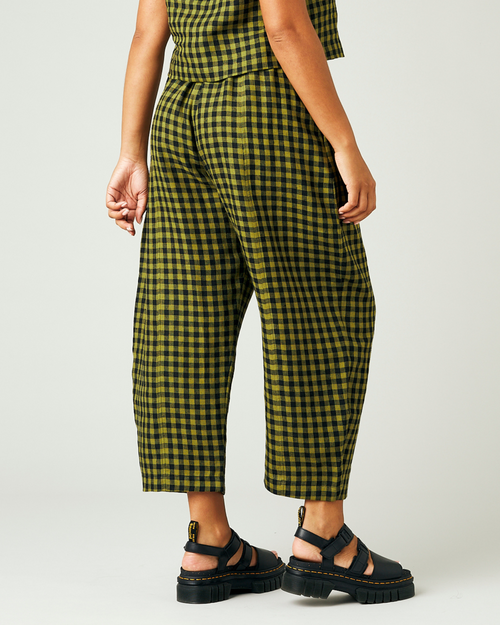 model wears green gingham linen mabel trousers from the right