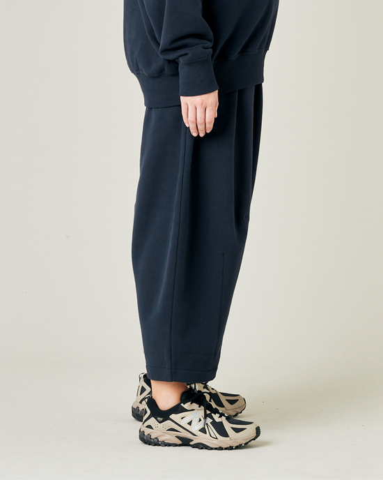 model wears navy daisy jersey trousers right