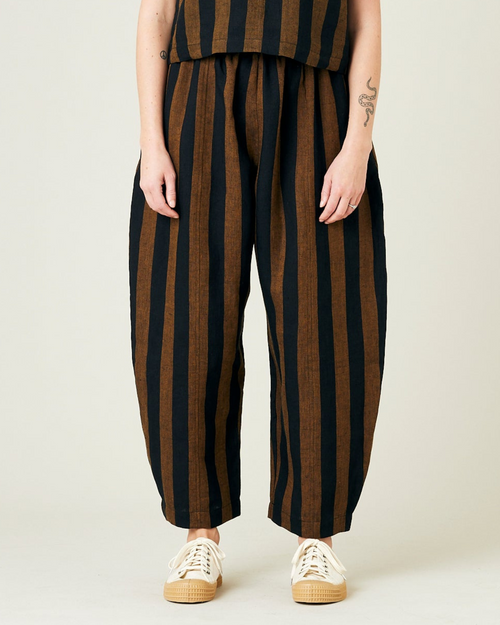 model wears rust stripe linen mabel trousers from the front