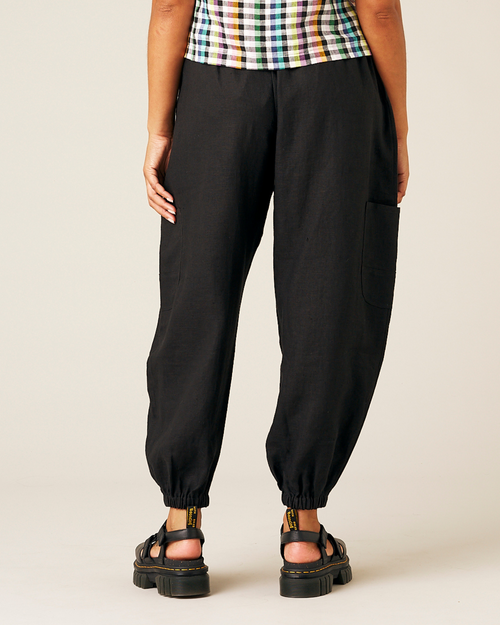 model wears black linen yoli trousers back