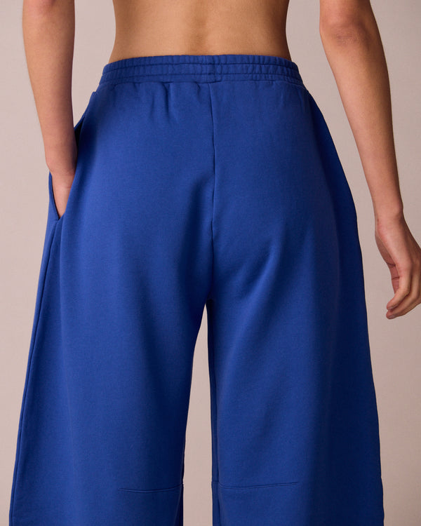 model wears daisy cobalt jersey fleeceback trousers