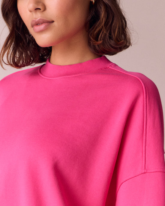 model wears eden hot pink fleeceback jersey jumper