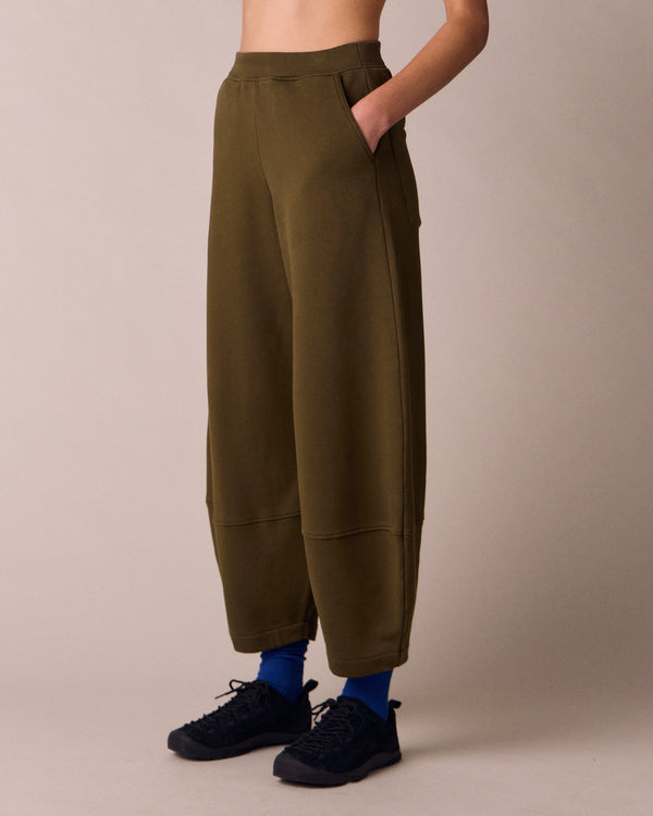 model wears pascale earth green jersey trousers left