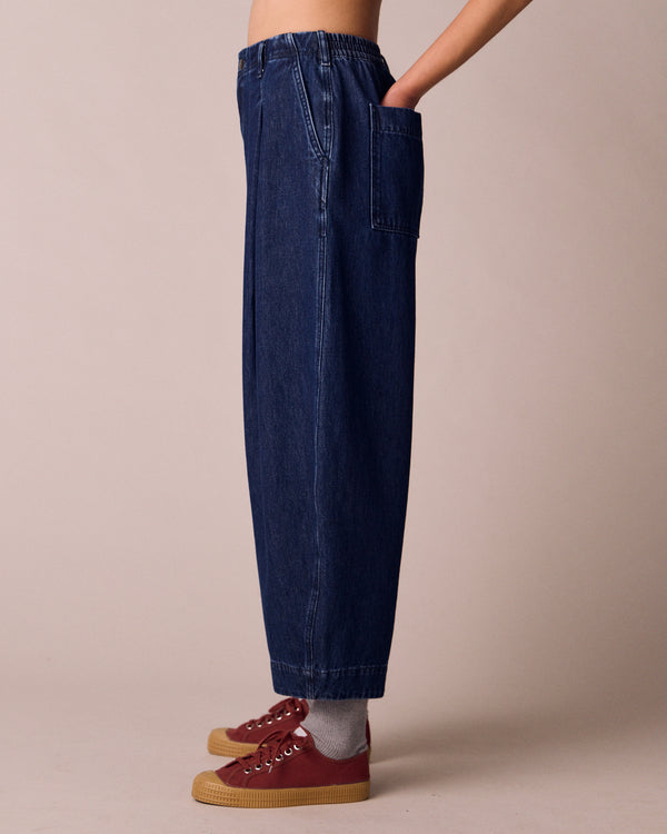 model wears veda dark wash denim jeans left