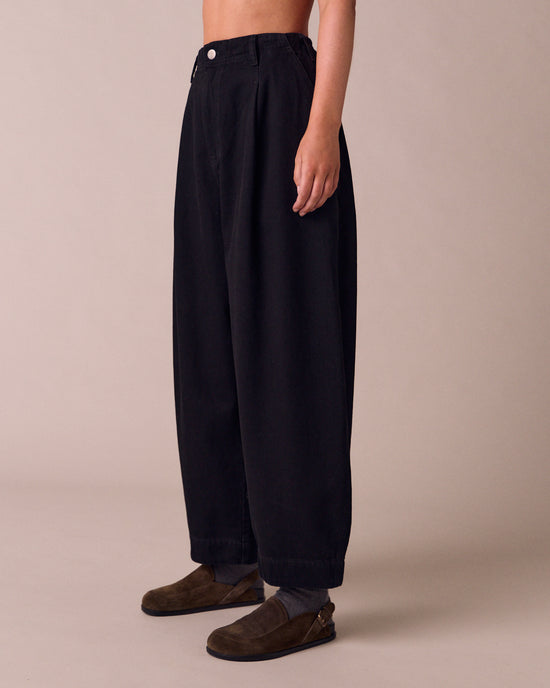model wears veda true black denim jeans left