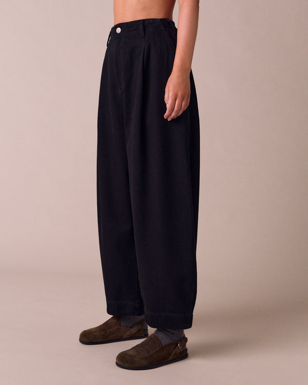 model wears veda true black denim jeans left