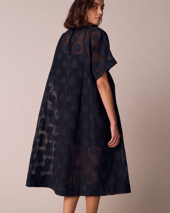 model wears zyla black sheer spot dress