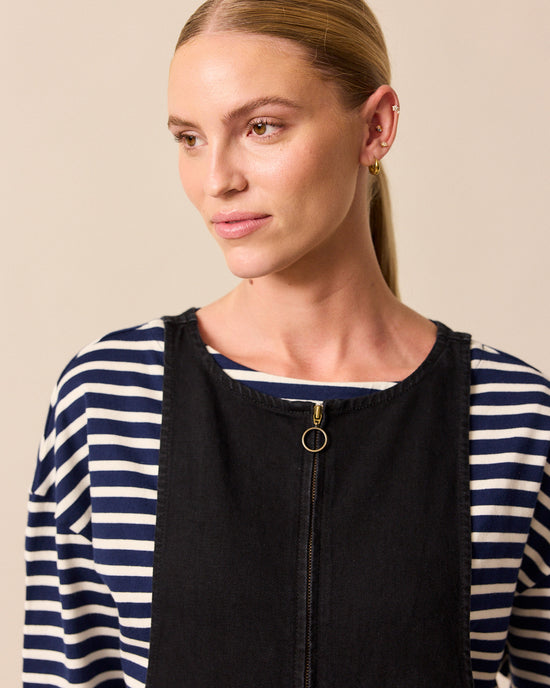 model wears ada black denim jumpsuit