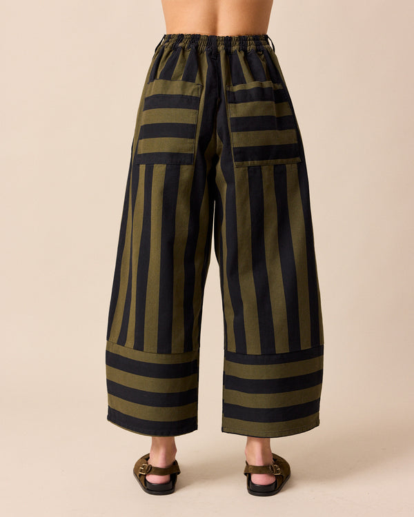 model wears blair olive and black stripe denim trousers back