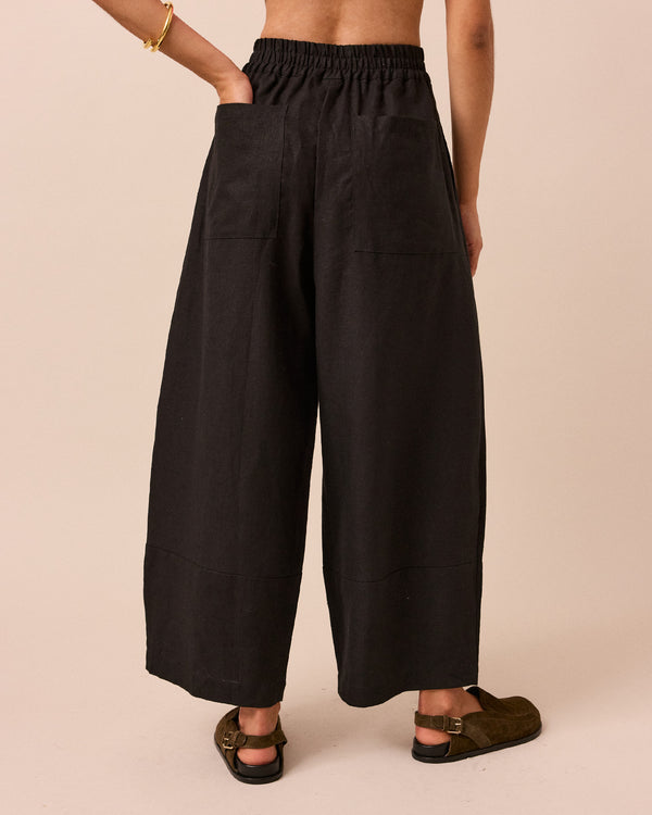 model wears black bobbi linen trousers back