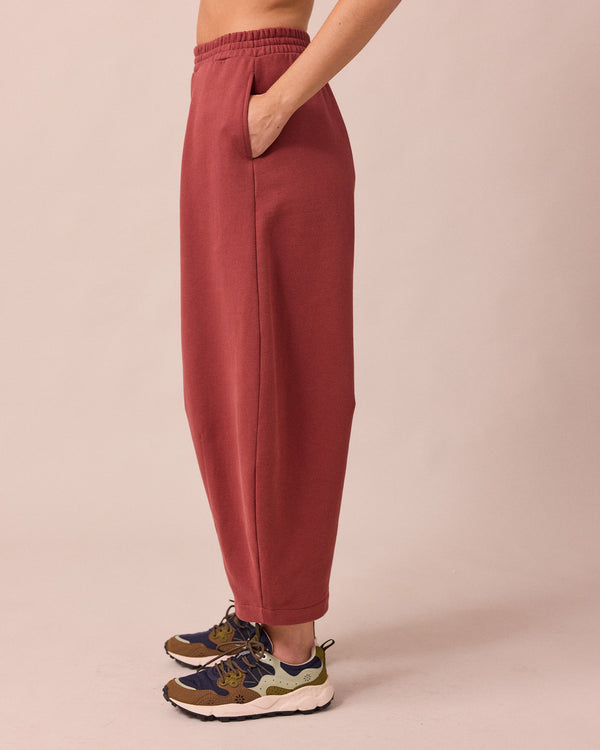 model wears daisy brick fleece jersey trousers left
