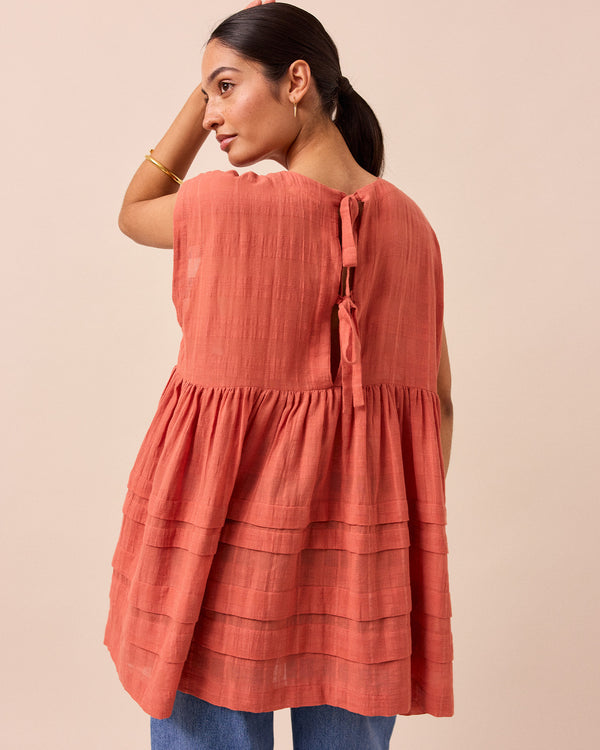 model wears ella terracotta cotton gauze dress