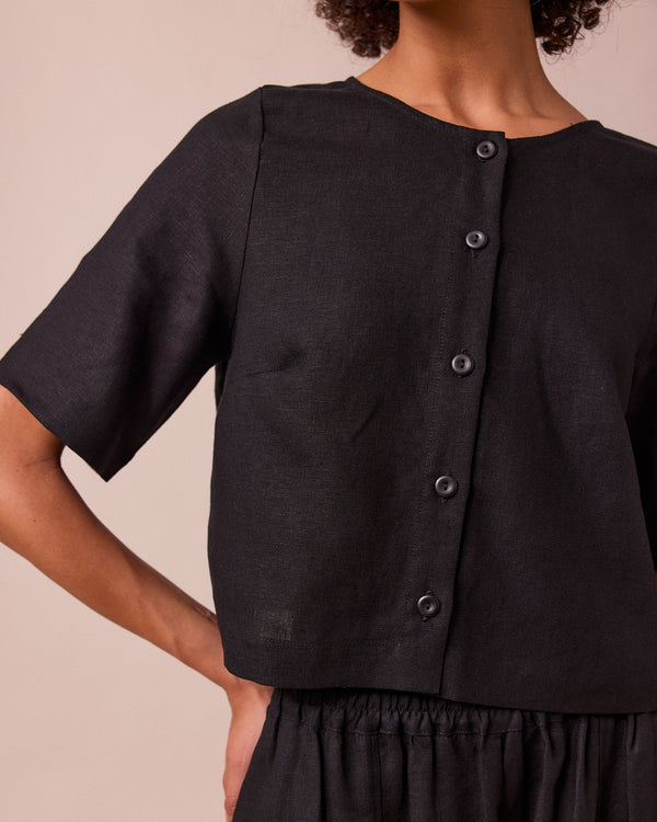 model wears evelyn black linen top
