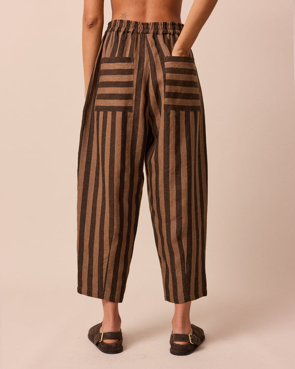 model wears walnut stripe huxley linen trousers back