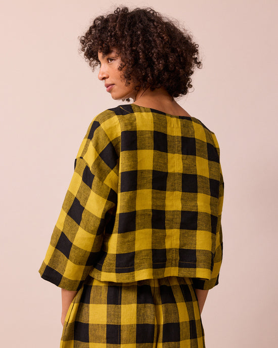 model wears lily chartreuse check linen top