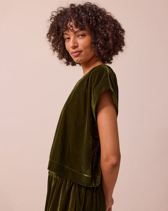 model wears polly moss green velvet top