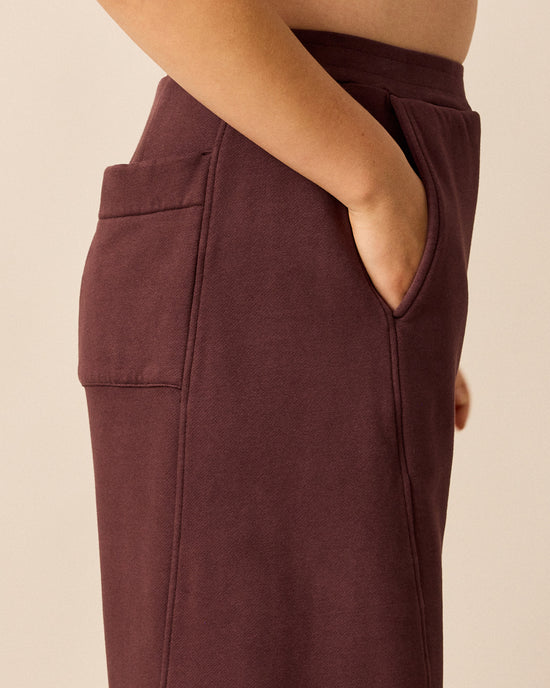 model wears lyra burgundy fleeceback jersey trousers