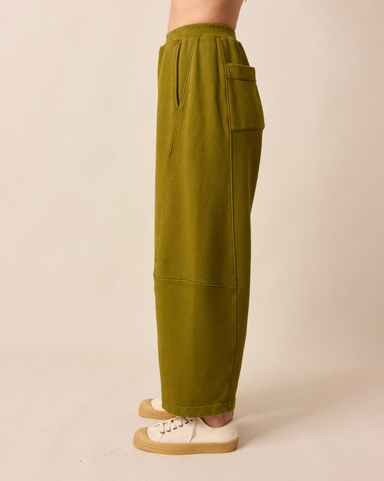 model wears lyra fresh olive jersey trousers left