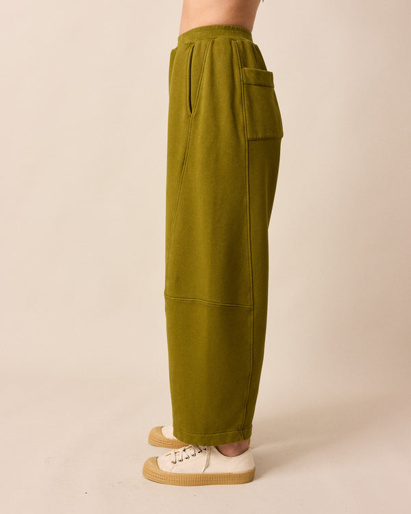 model wears lyra fresh olive jersey trousers left