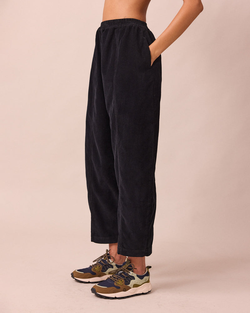 model wears mabel black cord trousers left