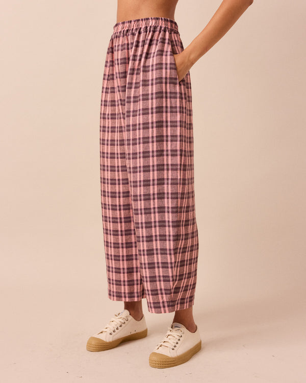 model wears mabel dewberry check linen trousers left