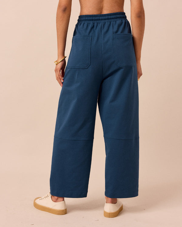 model wears madi french navy jersey trousers back