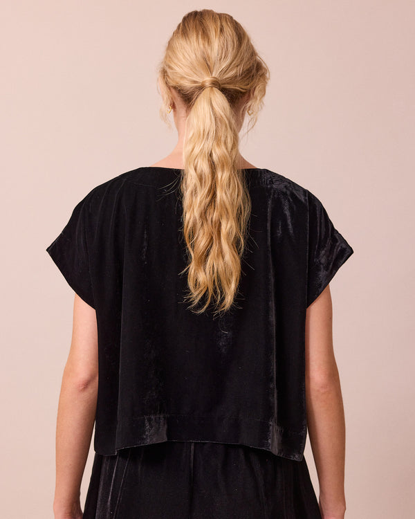 model wears polly black velvet top