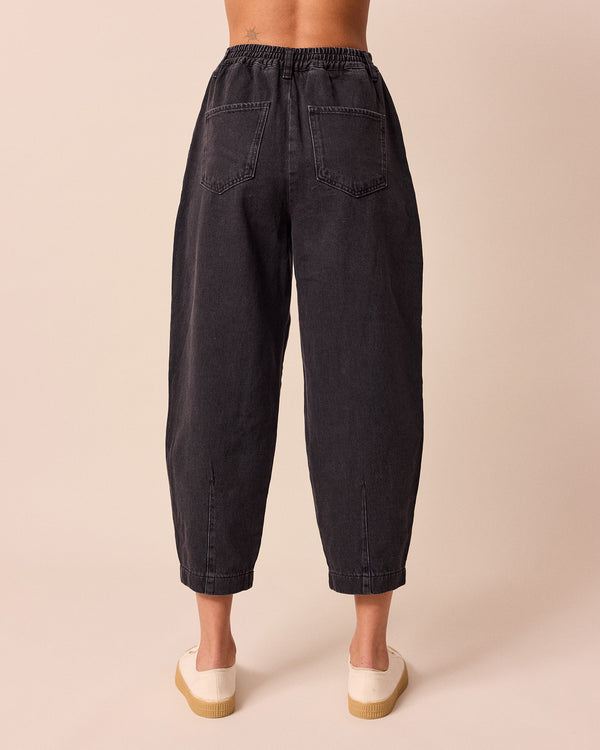 model wears remi washed black jeans front right