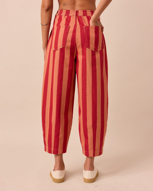 model wears peach and russet remi denim trousers back