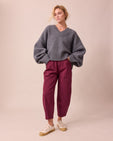 model wears remi russet and violet denim jeans right
