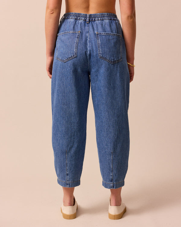 model wears remi true blue denim jeans left