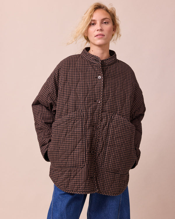 model wears rue cocoa gingham denim jacket