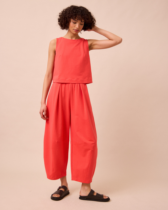 model wears daisy watermelon jersey trousers left