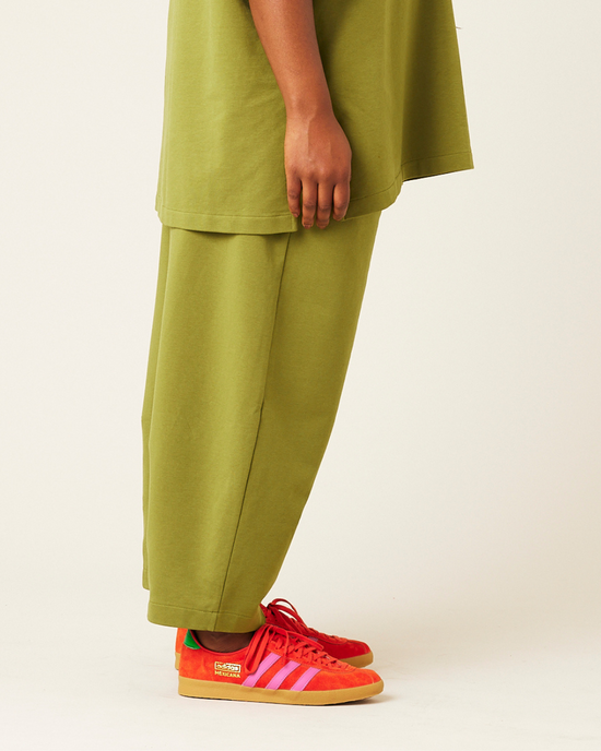 model wears moss green jersey huxley trousers right