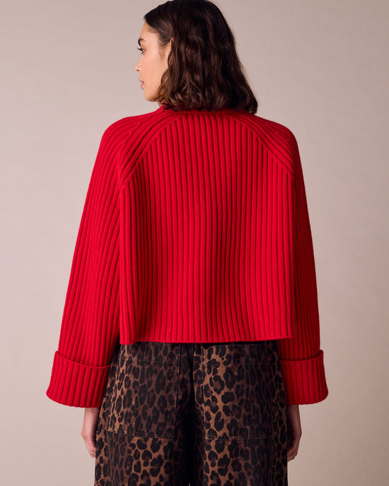 model wears cadi cherry red knitted jumper