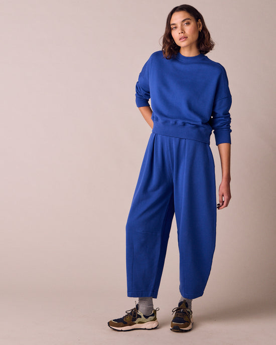 model wears daisy cobalt jersey fleeceback trousers back