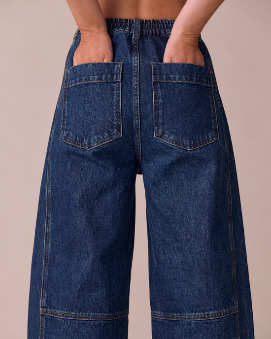 model wears echo mid wash denim jeans right