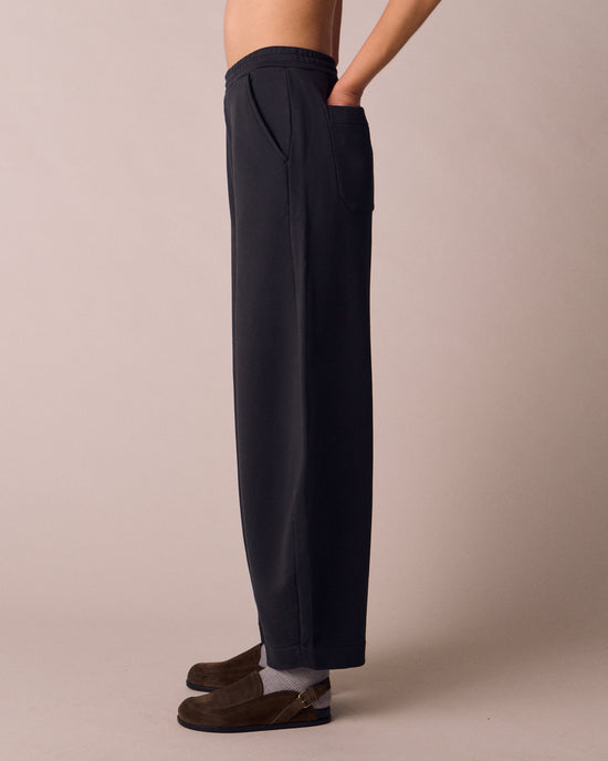 model wears helina washed black jersey trousers left
